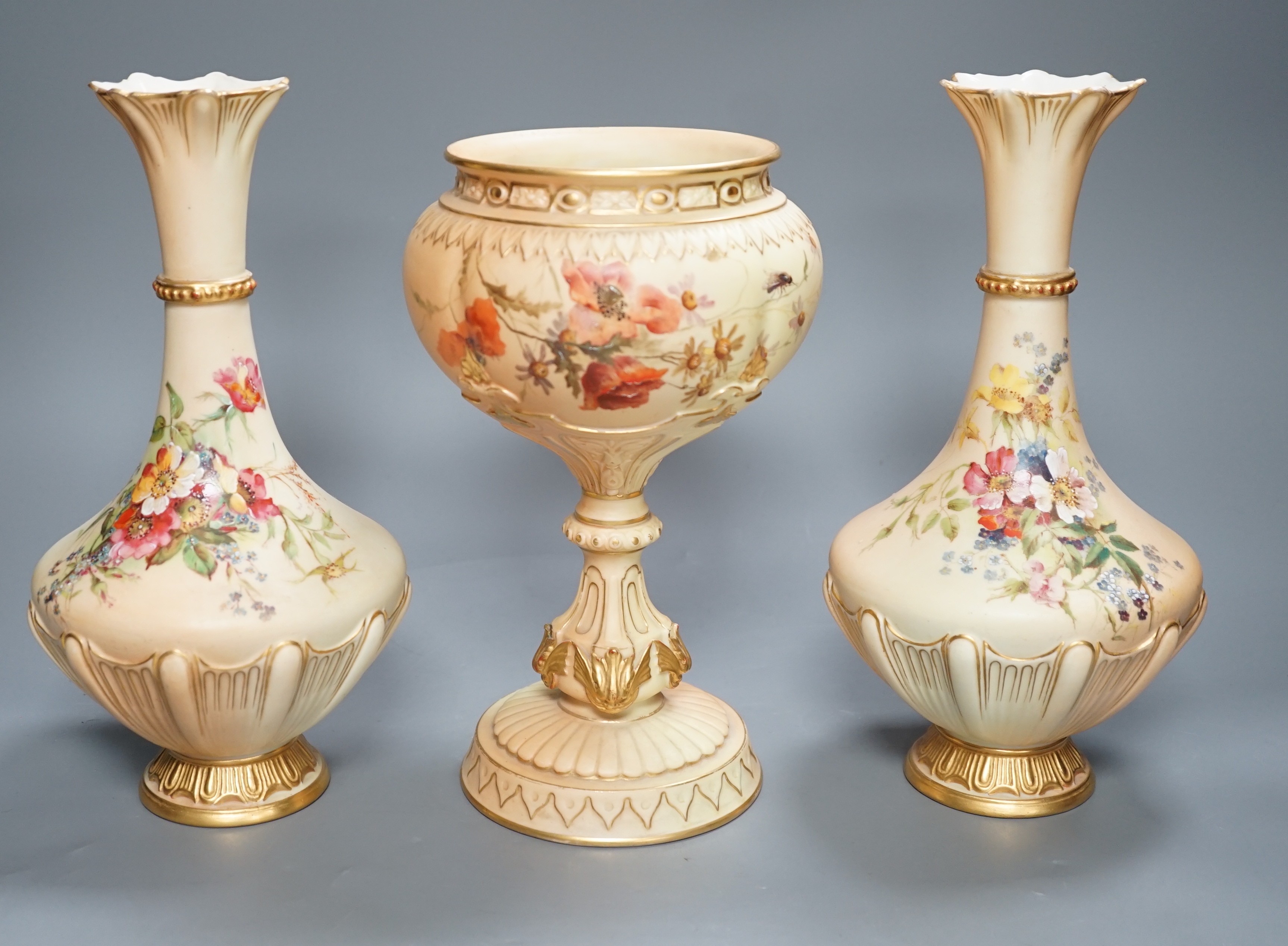 A pair of Royal Worcester blush ivory vases and a similar pedestal vase, tallest 27cm